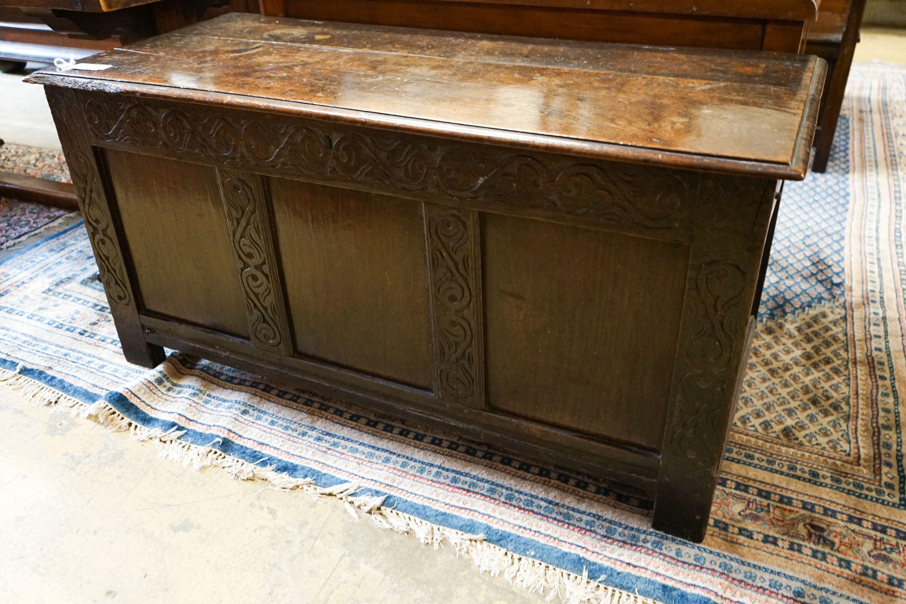 A late 17th / early 18th century carved and panelled oak coffer, length 136cm, depth 58cm, height 66cm